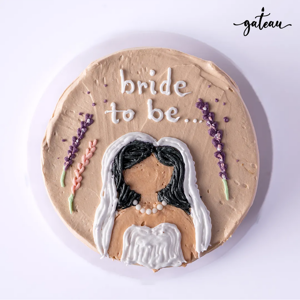 Gateau Gourmet Cafe bride to be cake with a bride decoration and floral accents on beige frosting