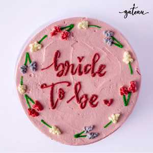 Pink frosted bride to be cake with colorful floral decorations from Gateau Gourmet Cafe
