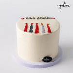 Gateau Gourmet Cafe candle bundle cake with white frosting and five colorful candle designs on top