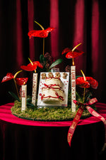 Canvas Classic Cake with Flowers by Gateau Gourmet Cafe displayed on moss with red anthurium flowers and decorative candles