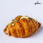 Cheese zaatar croissant with melted cheese and zaatar seasoning from Gateau Gourmet Cafe on white background