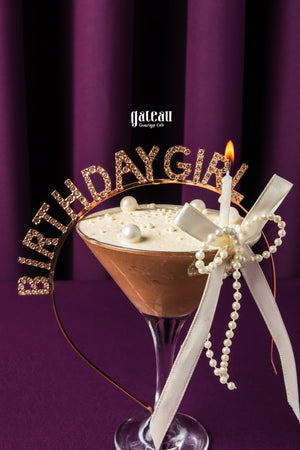 Gateau Gourmet Cafe chocolate mousse birthday dessert in glass with lit candle and decorative birthdaygirl headband