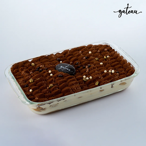 Gateau Gourmet Cafe classic tiramisu dessert in a glass tray with cocoa powder and chocolate pearls