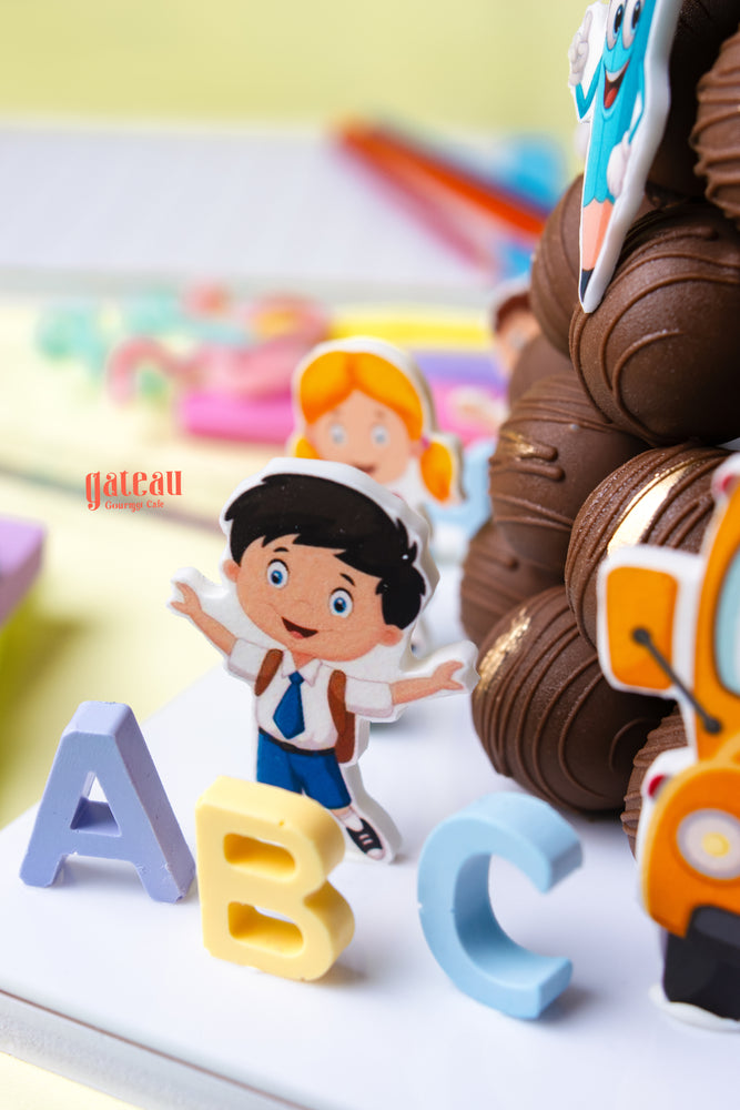 Colorful classroom theme cake with playful character toppings for educational celebrations