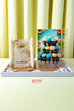 Colorful cupcakes for summer party displayed on a tiered stand beside a decorative calendar cake by Gateau Gourmet Cafe