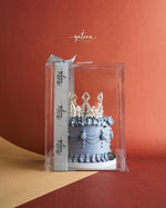 Crown Cake for Celebrations by Gateau Gourmet Cafe with blue frosting and decorative silver crown topper in clear box