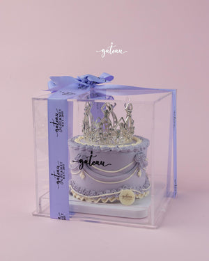 Gateau Gourmet Cafe crown cake for celebrations in purple with silver crown topper inside clear gift box