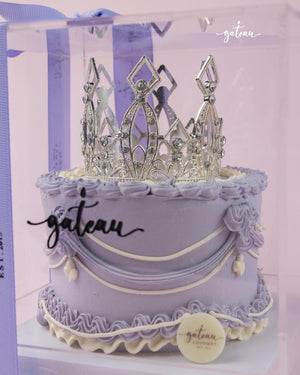 Purple crown cake for celebrations by Gateau Gourmet Cafe with silver decorative crown topper