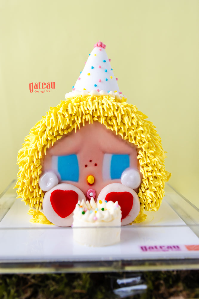 CRYBABY Powerpuff cake edition with yellow icing hair and party hat by Gateau Gourmet Cafe
