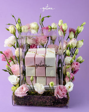 Gateau Gourmet Cafe cube cake gift box with pink and white cakes surrounded by fresh flowers