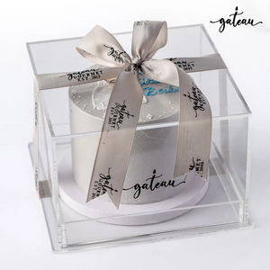 Gateau Gourmet Cafe custom birthday cake in clear box with branded ribbon and decorative white frosting