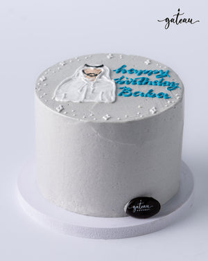 Minimalist white custom birthday cake with blue lettering and cat design from Gateau Gourmet Cafe