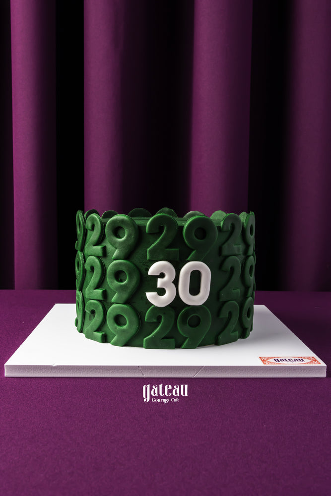 Gateau Gourmet Cafe custom birthday cake with green number 29 design and white number 30 centerpiece