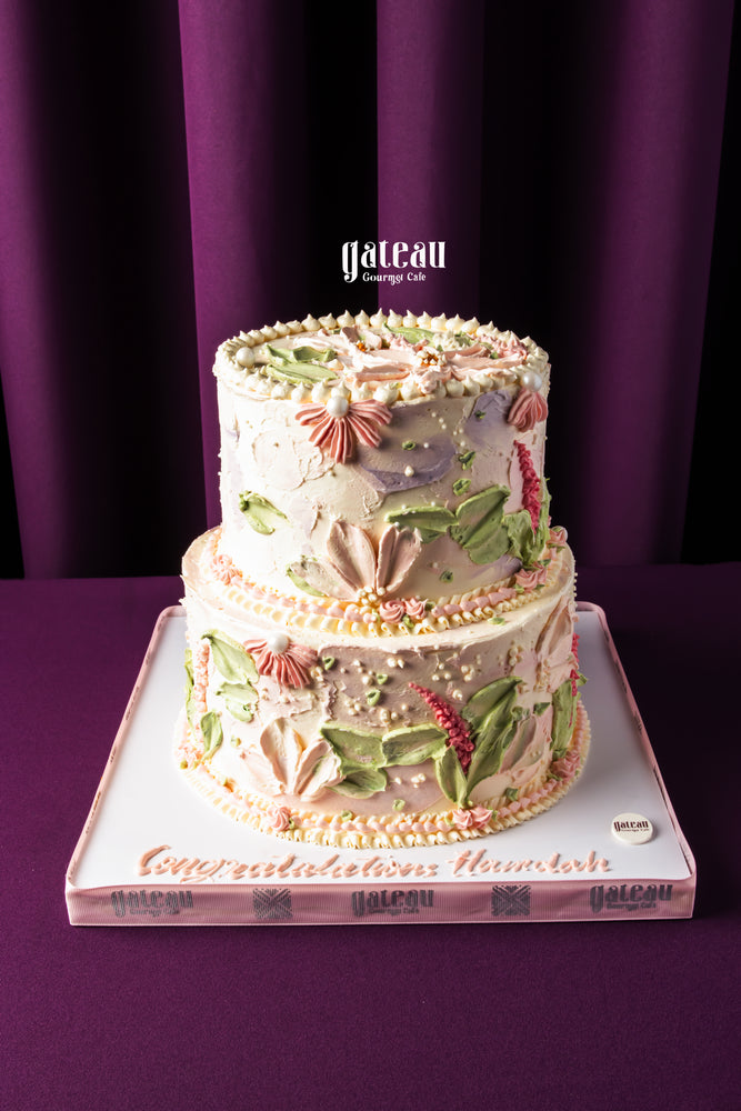 Gateau Gourmet Cafe custom birthday cakes two-tier floral design with pastel colors and pearl decorations