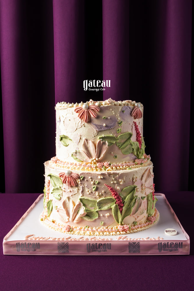 Two-tier custom birthday cakes with floral buttercream decorations by Gateau Gourmet Cafe