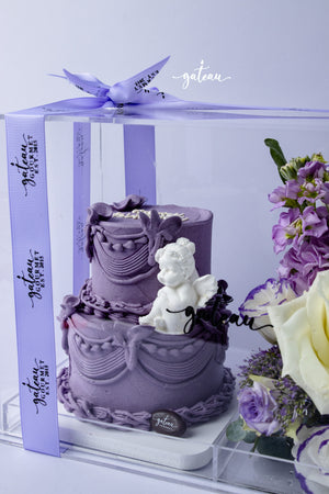 Purple two-tier custom cake arrangements with white angel decoration from Gateau Gourmet Cafe in clear gift box