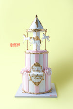 Custom carousel birthday cake from Gateau Gourmet Cafe with pink stripes and white horses