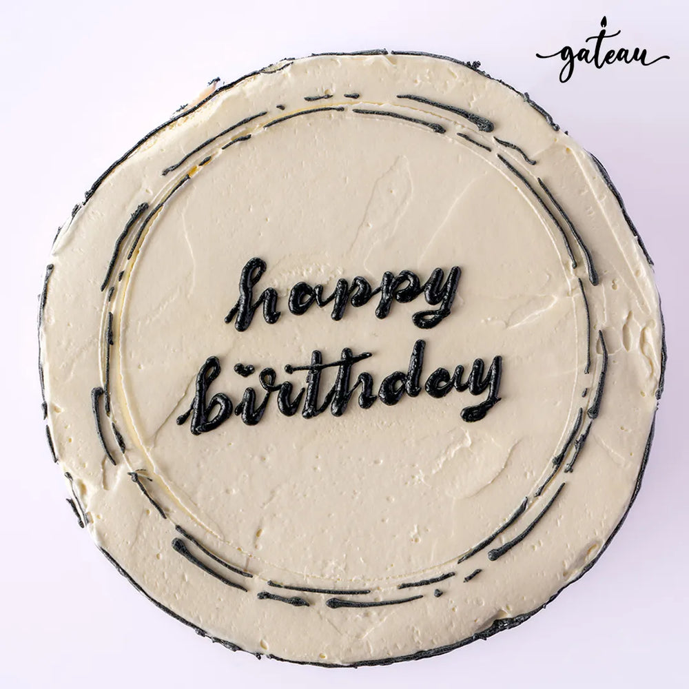 Custom colored cakes from Gateau Gourmet Cafe featuring a 'Happy Birthday' message on a cream frosting