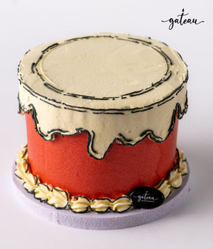 Custom colored cakes from Gateau Gourmet Cafe topped with creamy frosting and decorative piping
