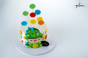 Custom dinosaur party cake featuring colorful decorations and a cute dinosaur topper for celebrations
