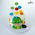 Custom dinosaur party cake featuring colorful decorations and a playful dinosaur design