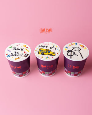 Gateau Gourmet Cafe custom festival cakes with back to school and welcome back themes in purple containers