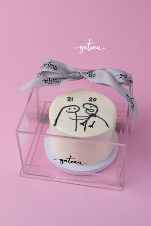 Custom flork cake by Gateau Gourmet Cafe with simple stick figure design in transparent gift box