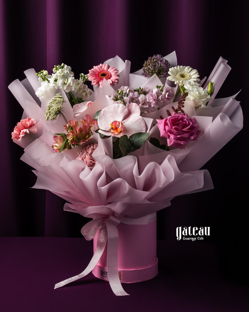 Elegant custom flower bouquet services featuring a variety of colorful blooms in a pink bouquet box