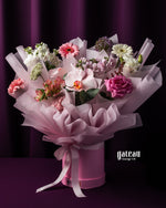 Elegant custom flower bouquet services featuring a variety of colorful blooms in a pink bouquet box