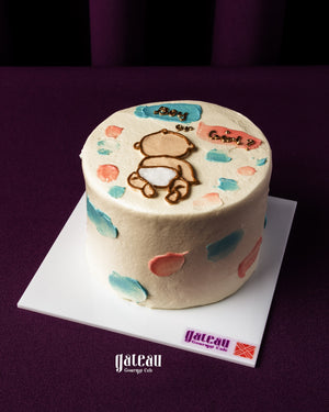 Custom gender reveal cake from Gateau Gourmet Cafe with pastel colors and baby design on top