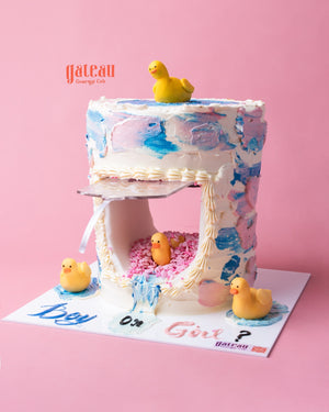 Custom gender reveal cake with pink and blue frosting, featuring rubber ducks and sprinkles for a fun celebration