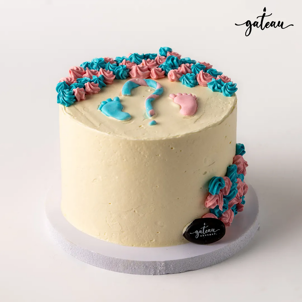Custom gender reveal cake with blue and pink frosting decorations at Gateau Gourmet Cafe