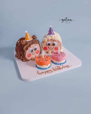 Custom Gibbous cake with two character faces and two small decorated birthday cakes by Gateau Gourmet Cafe