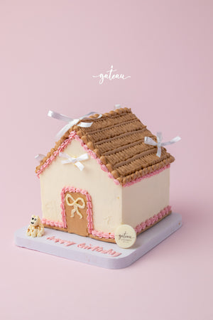 Custom house-shaped cake with brown roof and pink icing details from Gateau Gourmet Cafe