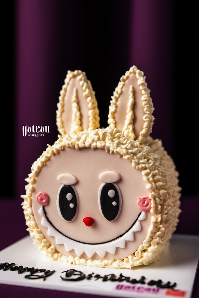 Custom labubu cake design featuring a playful bunny face with detailed frosting by Gateau Gourmet Cafe