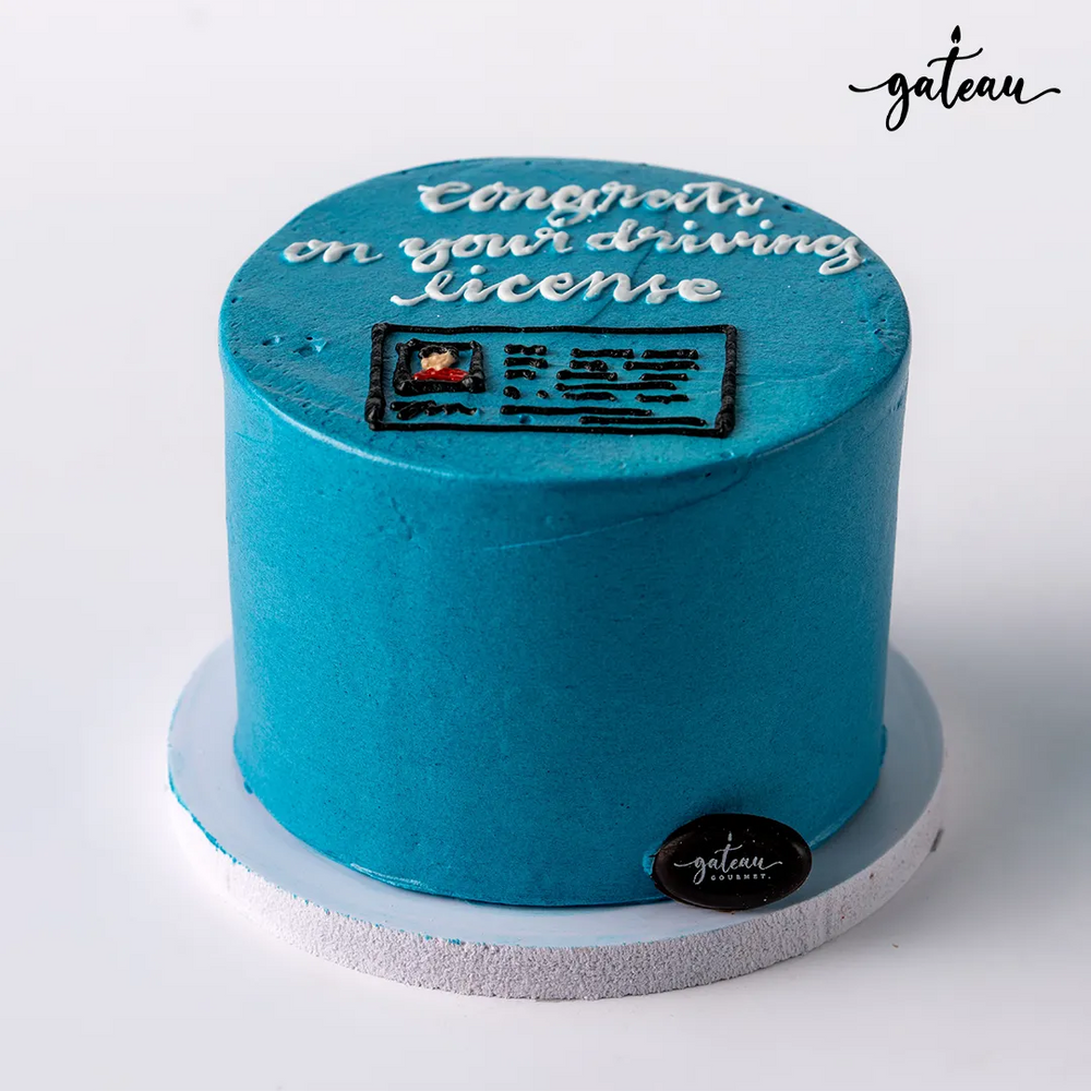Custom license celebration cake in blue with a driving license design and uplifting text