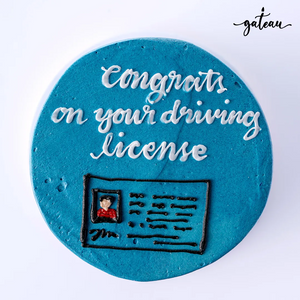 Custom license celebration cake in blue with driving license design and handwritten congratulations