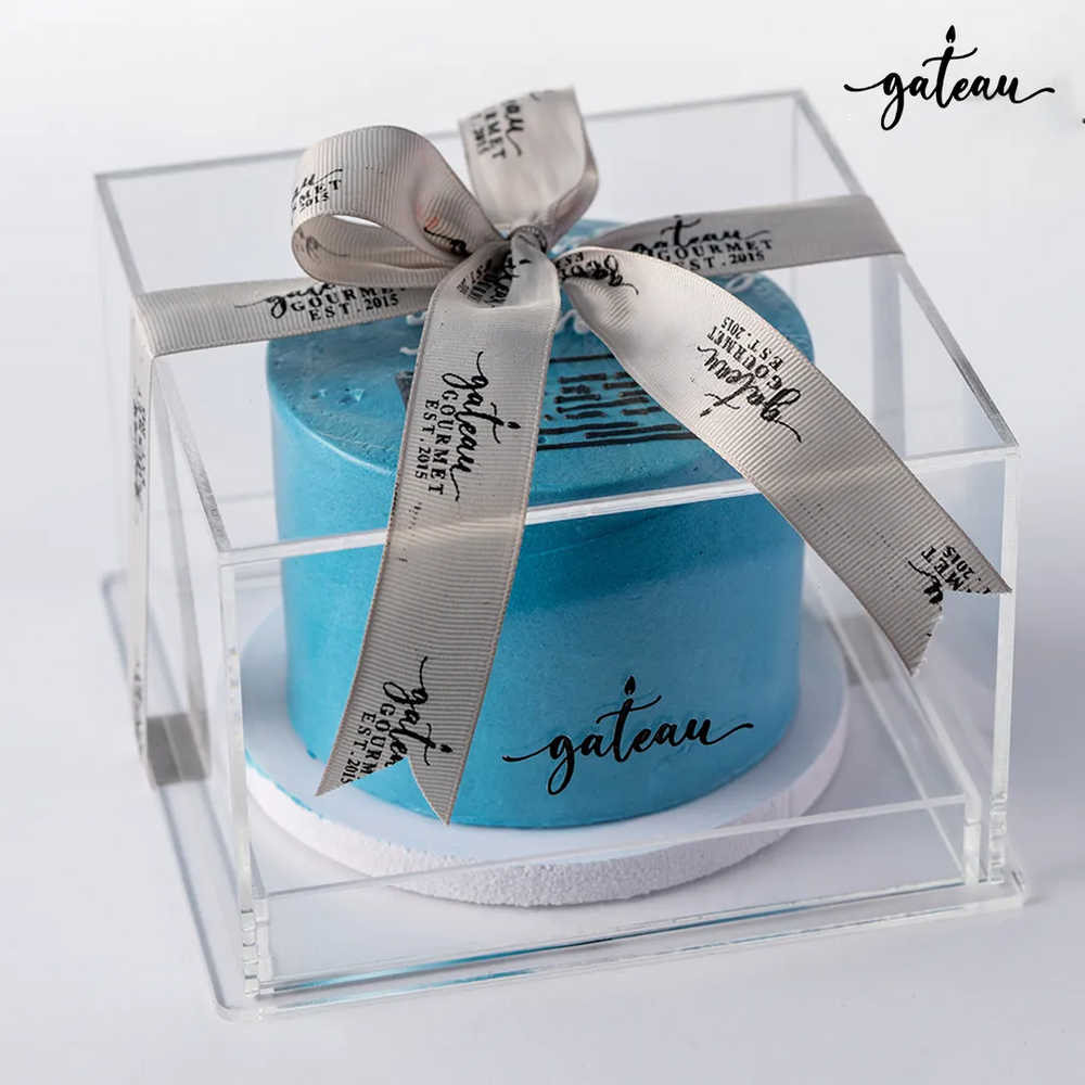 Custom license celebration cake by Gateau Gourmet Cafe with a blue frosting and elegant packaging