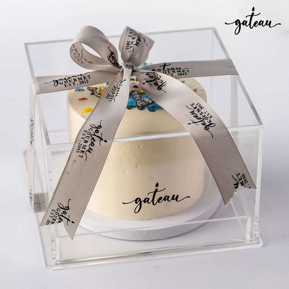 Gateau Gourmet Cafe custom minion birthday cake in clear gift box with branded ribbon