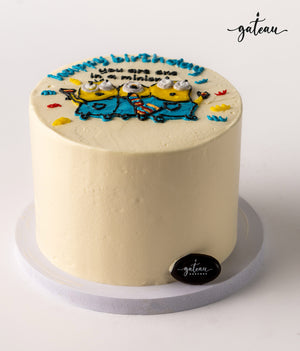 Gateau Gourmet Cafe custom minion birthday cake with white frosting and colorful Minion design