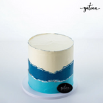 Gateau Gourmet Cafe custom ombre birthday cake with layered blue and white frosting on a white base