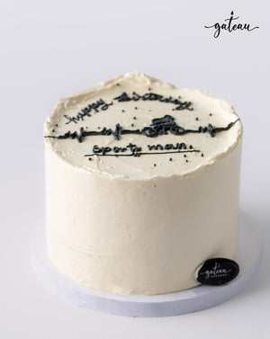 White custom sports cake with black icing design and happy anniversary message from Gateau Gourmet Cafe