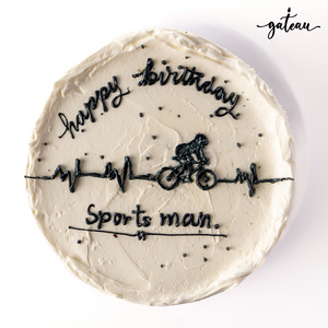 Gateau Gourmet Cafe custom sports cake with white frosting and black cyclist design for birthdays
