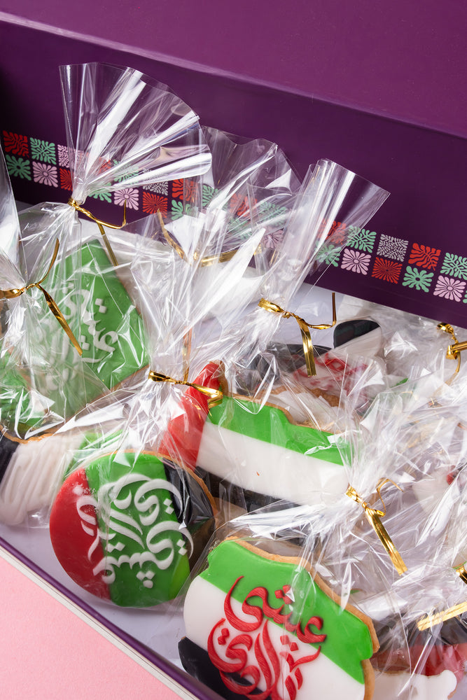 Box of custom UAE themed cookies with vibrant colors and intricate designs for special celebrations