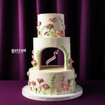 Elegant three-tier custom wedding cake design with pink floral decorations by Gateau Gourmet Cafe