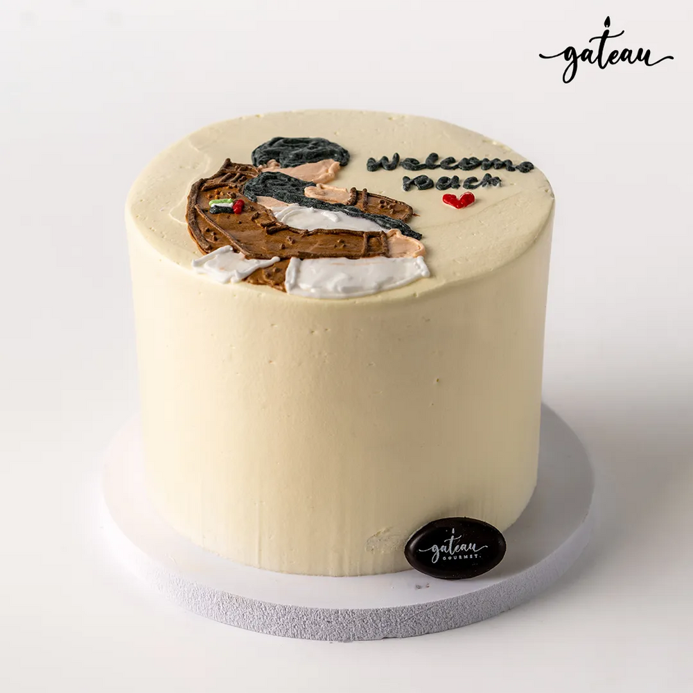 Gateau Gourmet Cafe custom welcome back cake with cream frosting and hand-decorated figure on top