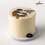 Gateau Gourmet Cafe custom welcome back cake with cream frosting and hand-decorated figure on top