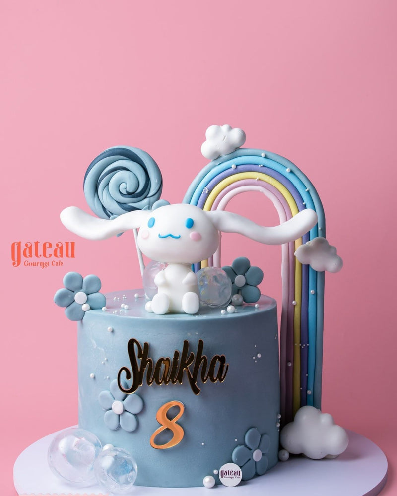 Cute character cake with rainbow, clouds, and bunny for celebrations at Gateau Gourmet Cafe, cute character cakes near me