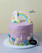 Cute Cinnamoroll Cake with a colorful rainbow and floral decorations for a first birthday celebration