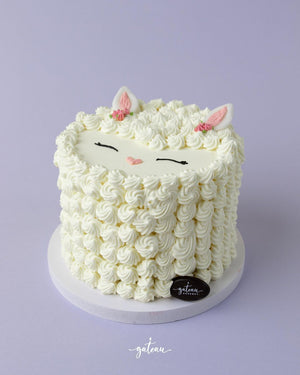 Cute sheep cake from Gateau Gourmet Cafe decorated with fluffy frosting and adorable features